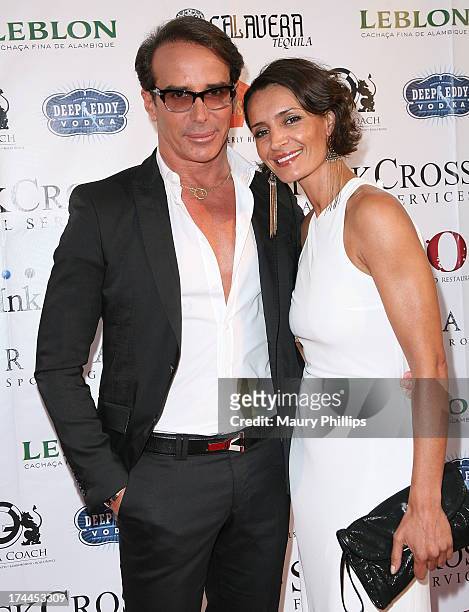Fashion Designer Lloyd Klein and Bahia Haifi arrives at the 40th Anniversary StockCross Party on July 25, 2013 in Beverly Hills, California.