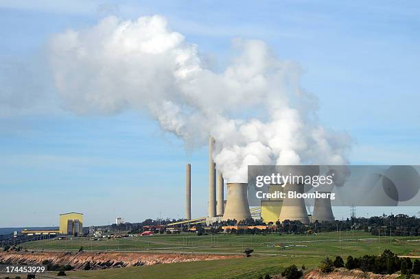 Steam billows from the cooling towers at the Loy Yang A coal-fired power station, operated by AGL Energy Ltd., front, and Loy Yang B coal-fired power...