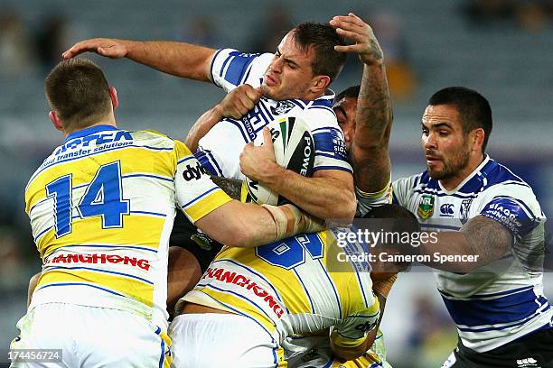 Josh Reynolds of the Bulldogs is tackled during the round 20 NRL match between the Canterbury Bulldogs and the Parramatta Eels at ANZ Stadium on July...