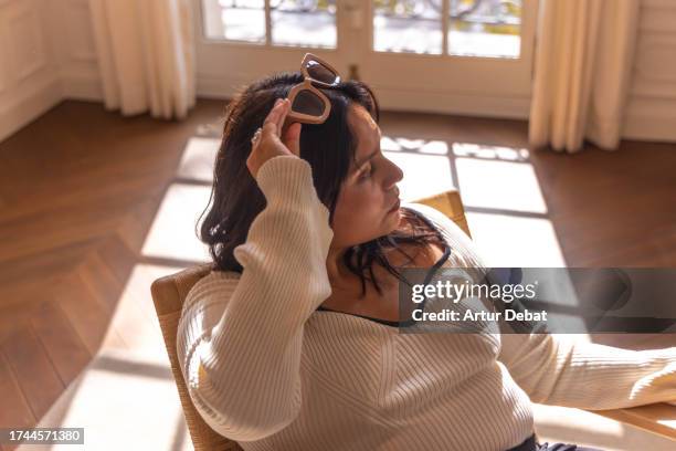 headshot portrait of a sophisticated latin woman in a bright apartment. - lampshade skirt stock pictures, royalty-free photos & images