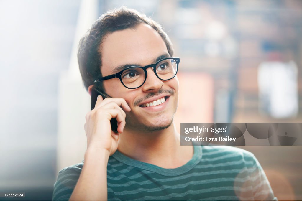 Man chatting on his mobile phone in a coffee shop