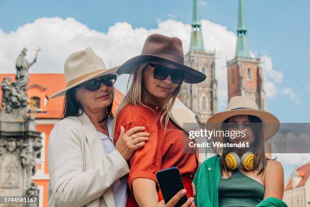 smiling woman taking selfie with family through smart phone - fashionable grandma stock pictures, royalty-free photos & images