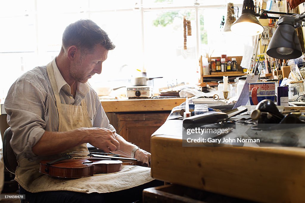 Man at work in violin shop
