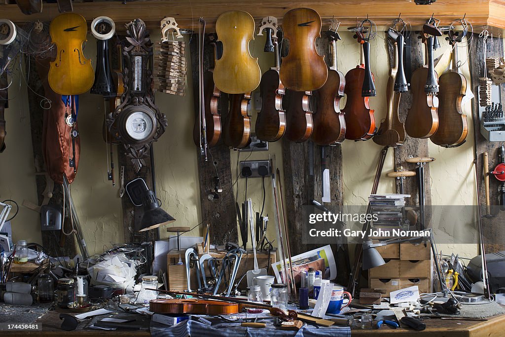 Violins hanging in workshop