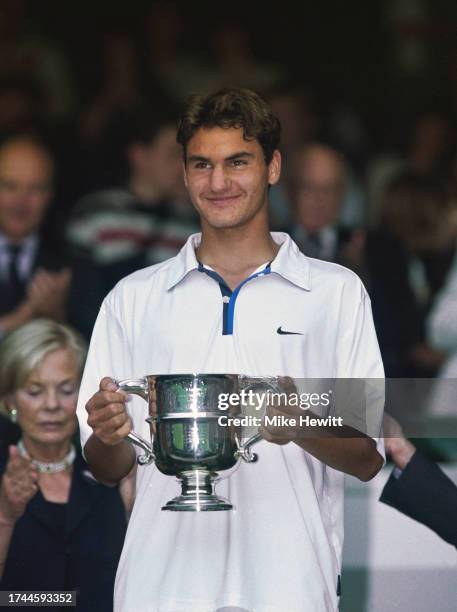 Roger Federer of Switzerland winner of the Boys Singles Tennis title holds the trophy at Wimbledon on July 5th, 1998 in London, England.