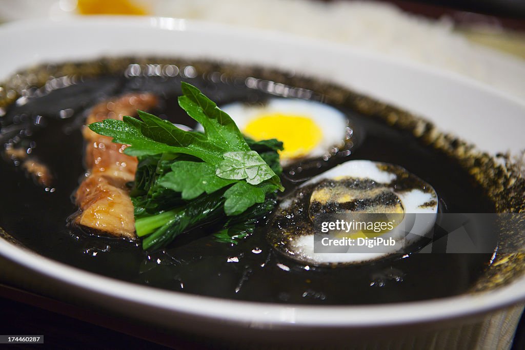 Squid ink curry served in white plate