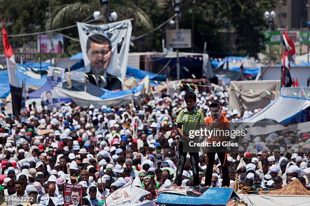 Supporters of deposed Egyptian President Mohammed Morsi take part in a demonstration at the Rabaa al-Adweya mosque in the district of Nasr City on...