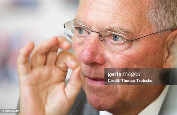 German Finance Minister Wolfgang Schaeuble gestures during an interview on July 23, 2013 in Berlin, Germany.