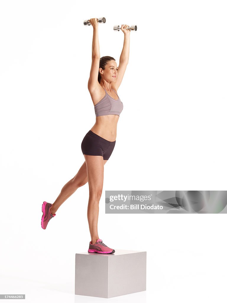 Woman on steps with weights