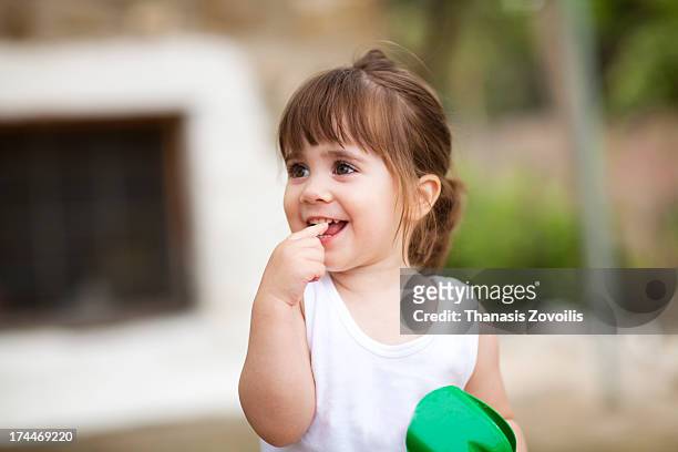 portrait of a cute small girl - finger in mouth fotografías e imágenes de stock
