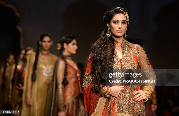 Bollywood Actress Nargis Fakhri shows creations by Fashion Designers Ashima and Leena during Indian Bridal Fashion Week in New Delhi July 26,2013....