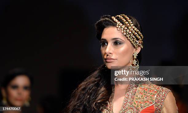 Bollywood Actress Nargis Fakhri shows creations by Fashion Designers Ashima and Leena during Indian Bridal Fashion Week in New Delhi July 26,2013....