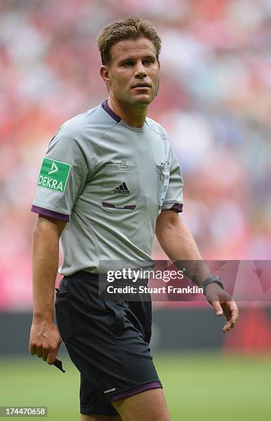 Referee Felix Brych ponders during the Uli Hoeness cup match between FC Bayern Munich and FC Barcelona at Allianz Arena on July 24, 2013 in Munich,...