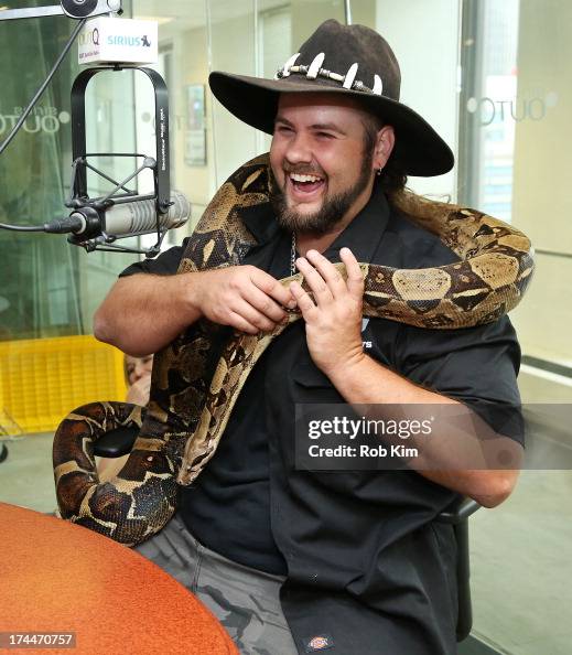 Jimmy Riffle of Animal Planet’s Gator Boys holds a boa snake as he