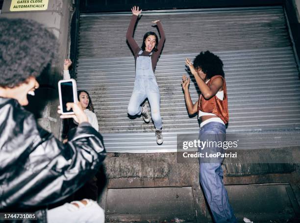 friends filming to share on social media at a party - nyc paparazzi stock pictures, royalty-free photos & images