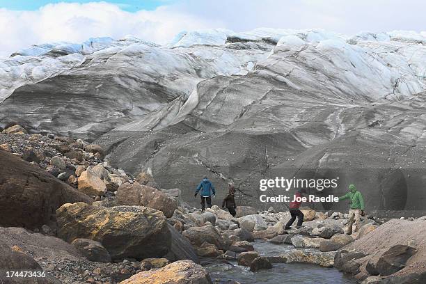 Ellen E. Martin, Department of Geological Sciences at the University of Florida, crosses in front of a glacier as she works with her team to analyze...