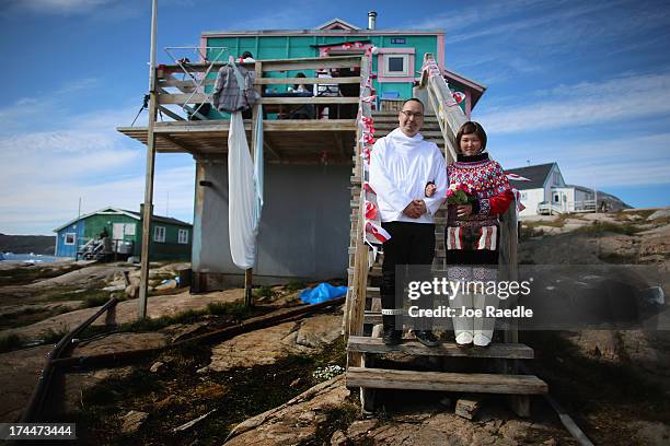 Ottilie Olsen and Adam Olsen pose for a picture on July 20, 2013 in Qeqertaq, Greenland. As Greenlanders adapt to the changing climate and go on with...