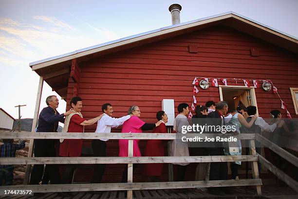 People dance during a wedding party on July 20, 2013 in Qeqertaq, Greenland. As Greenlanders adapt to the changing climate and go on with their...