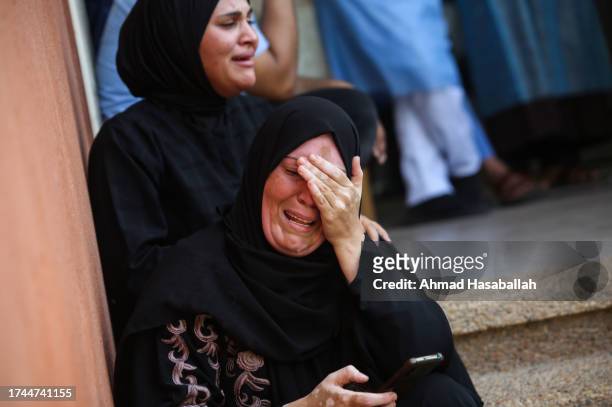 Woman cries as she bids farewell to the bodies of Palestinians killed during Israeli airstrikes on October 19, 2023 in Khan Yunis, Gaza. Gazans are...