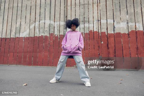 young woman portrait against a red wall - black culture stock pictures, royalty-free photos & images
