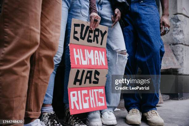 group of people marching for human rights - person justice imagens e fotografias de stock