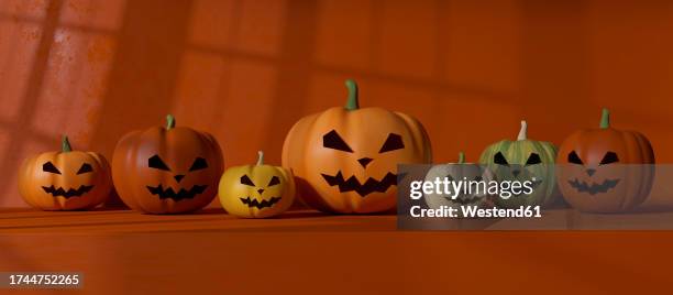 row of plastic jack o lanterns - smiley face stock pictures, royalty-free photos & images