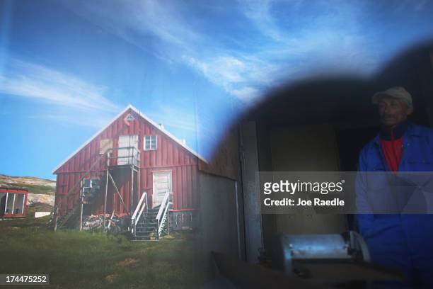 Kaalinnquaq Olsuig walks through the now abandoned home where his father lived on July 20, 2013 in Qeqertaq, Greenland. As Greenlanders adapt to the...