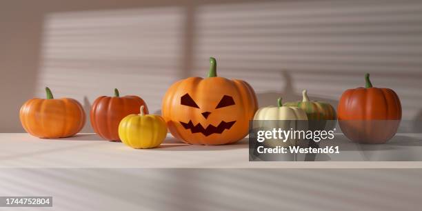 row of plastic pumpkins with jack o lantern in middle - smiley face stock pictures, royalty-free photos & images