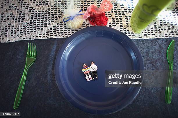 Beaded pin of two newly weds is seen on a dinner plate on July 20, 2013 in Qeqertaq, Greenland. As Greenlanders adapt to the changing climate and go...