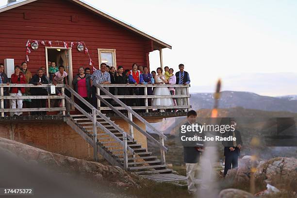 People watch as fireworks are launched during a wedding party on July 20, 2013 in Qeqertaq, Greenland. As Greenlanders adapt to the changing climate...
