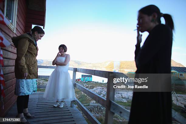 Ottilie Olsen and others from her wedding party take a break from dancing on July 20, 2013 in Qeqertaq, Greenland. As Greenlanders adapt to the...