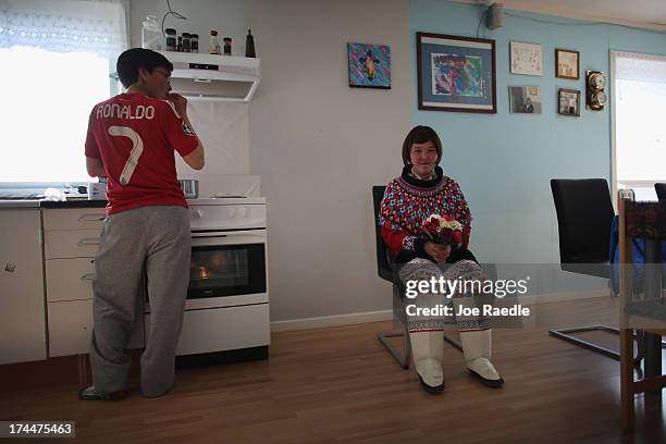 Ottilie Olsen sits in her wedding dress on July 20, 2013 in Qeqertaq, Greenland. As Greenlanders adapt to the changing climate and go on with their...