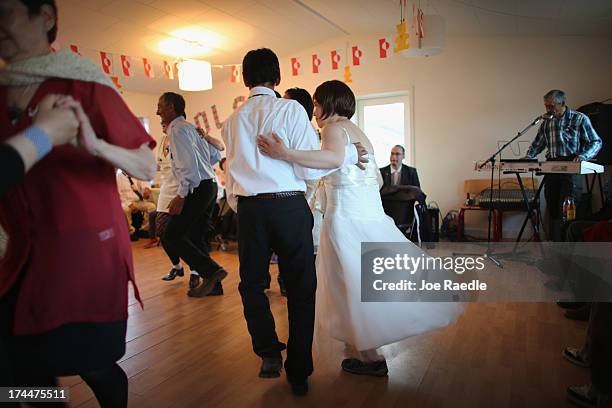 Wedding enjoys music and dance on July 20, 2013 in Qeqertaq, Greenland. As Greenlanders adapt to the changing climate and go on with their lives,...