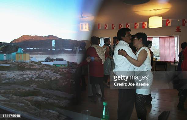 People dance during a wedding party on July 20, 2013 in Qeqertaq, Greenland. As Greenlanders adapt to the changing climate and go on with their...