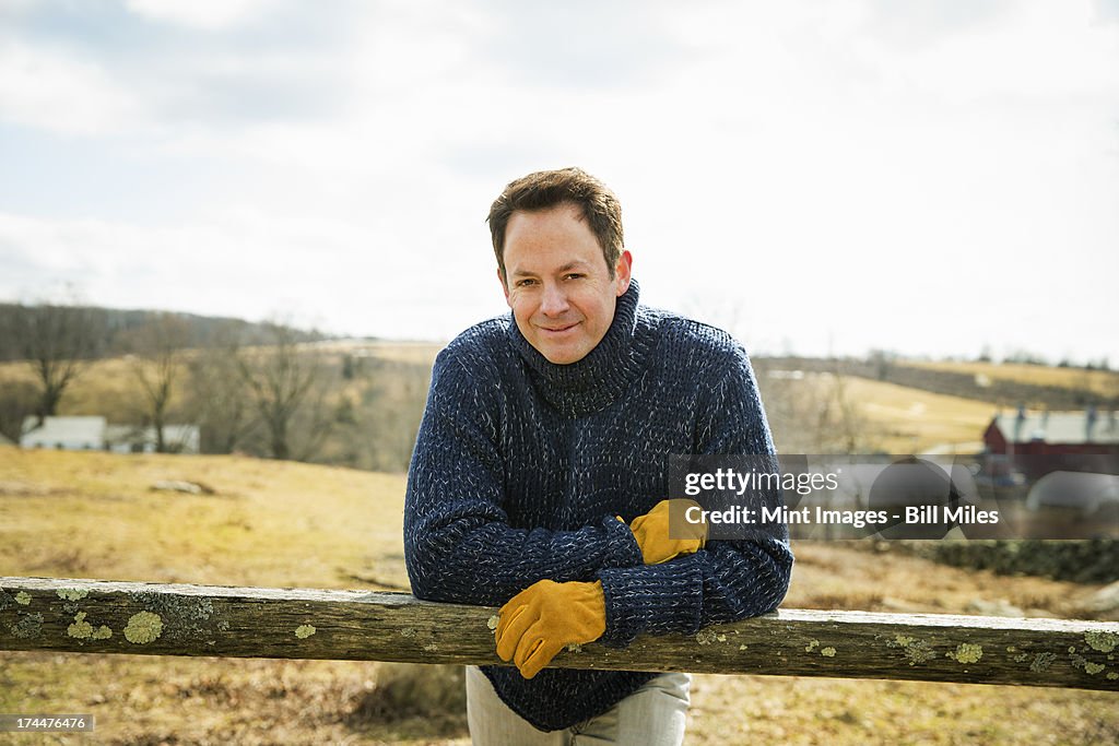 An Organic Farm in Winter in Cold Spring, New York State. A man working outdoors on the farm.
