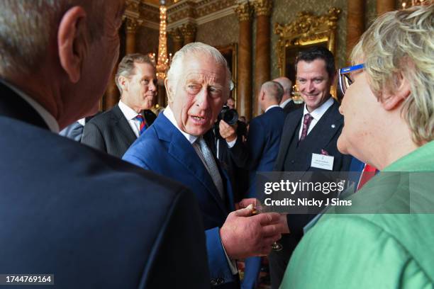 King Charles III meets with personnel involved in the planning of Queen Elizabeth's funeral and the King's Coronation during a reception at...