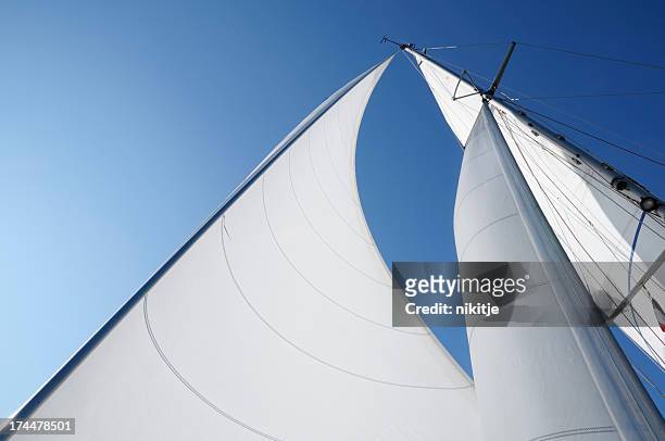 wind in the sails against blue sky - sail stock pictures, royalty-free photos & images