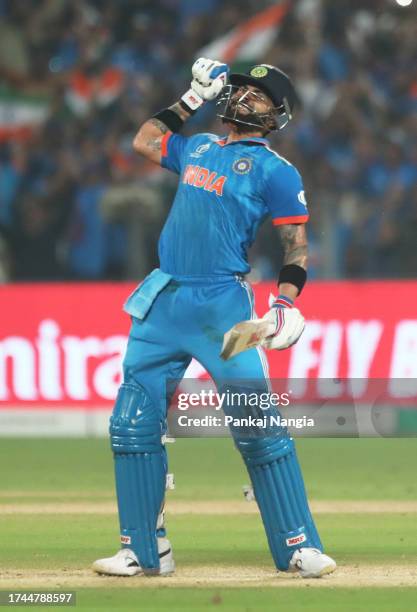 Virat Kohli of India celebrates their century as they hit the winning runs during the ICC Men's Cricket World Cup India 2023 between India and...