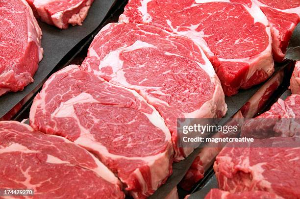 fresh ribeye steaks at the butcher shop - rood vlees stockfoto's en -beelden