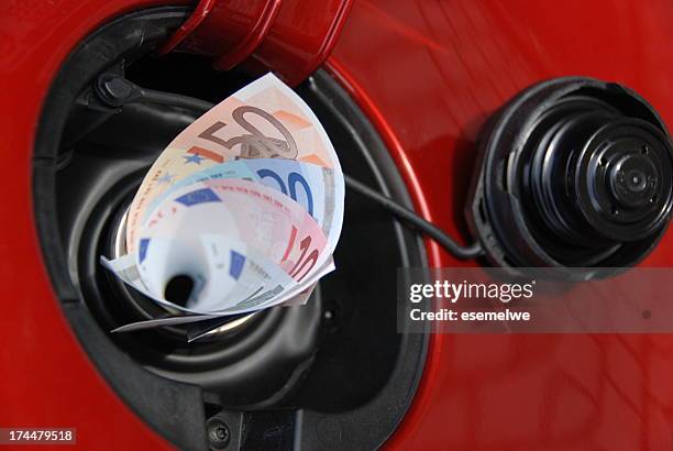 gas tank eats money - diesel stockfoto's en -beelden