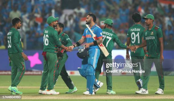 Virat Kohli of India and Litton Das of Bangladesh shake hands following the ICC Men's Cricket World Cup India 2023 between India and Bangladesh at...