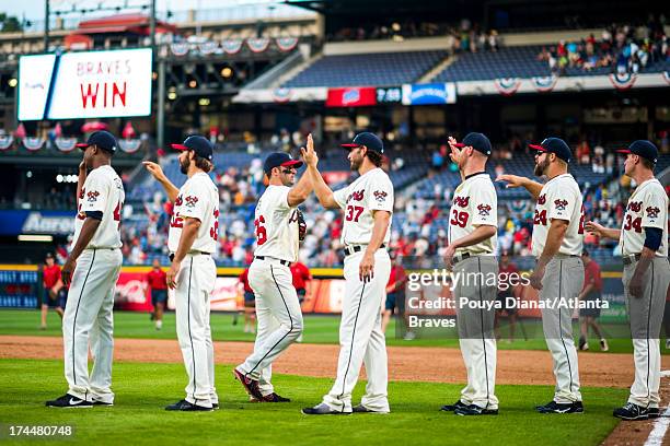 Dan Uggla and Brandon Beachy of the Atlanta Braves celebrate after the game against the Arizona Diamondbacks on June 29, 2013 in Atlanta, Georgia....