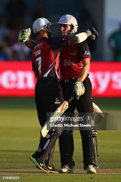 Chris Jones of Somerset Sabres is congratulated by team mate Peter Trego after completing his fifty and hitting the winning runs during the Friends...