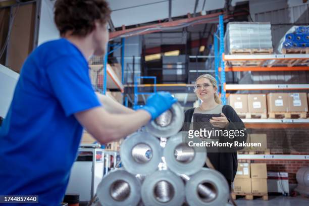 workers with tablet in discussion in factory - preston england stock pictures, royalty-free photos & images