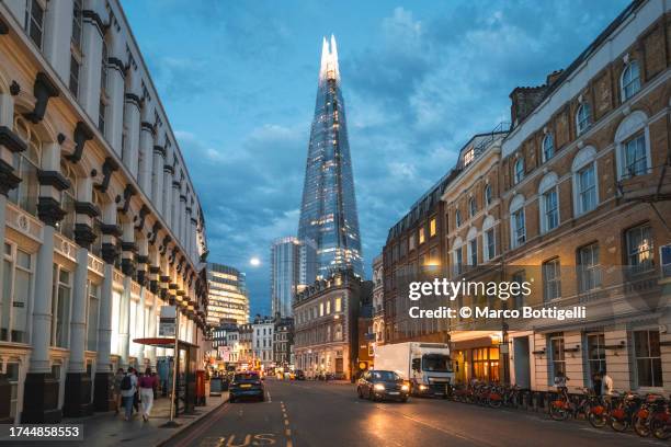 the shard and old buildings in london, uk - vehicle light stock pictures, royalty-free photos & images