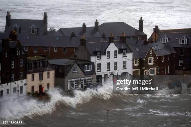 Waves crash over the harbour on October 19, 2023 in Stonehaven, Scotland. Rare Red weather warnings are in place in Scotland and amber warnings in...
