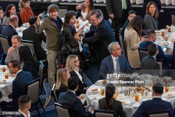 Climate activists disrupt an appearance by Federal Reserve Chair Jerome Powell at a lunch hosted by the Economic Club of New York at the Hilton Hotel...