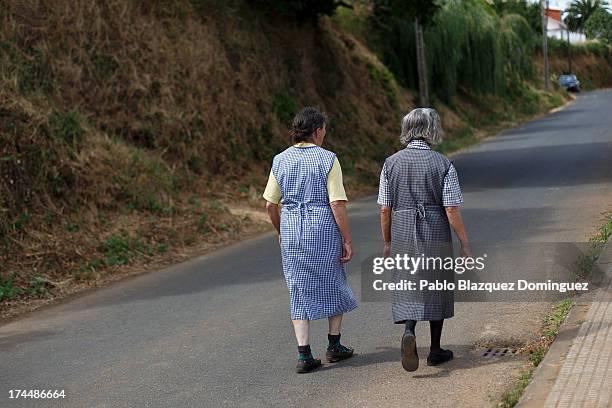 Angrois residents walk in the street on July 26, 2013 in Santiago de Compostela, Spain. The high speed train crashed after it derailed on a bend as...