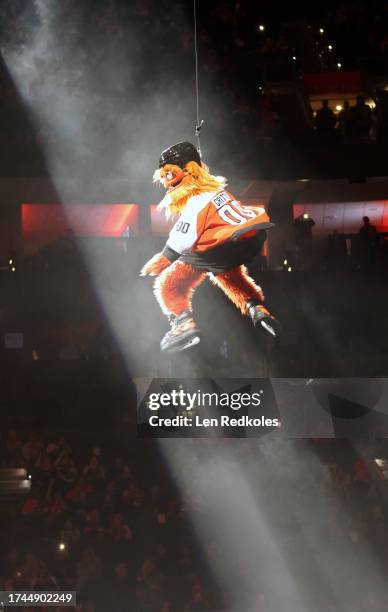 Gritty the mascot of the Philadelphia Flyers zipline downs to the ice prior to an NHL game against the Vancouver Canucks at the Wells Fargo Center on...