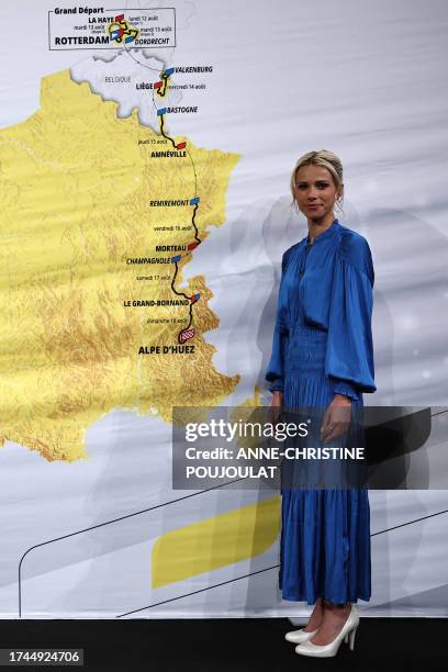 Director of the Women's Tour de France Marion Rousse poses in front of the map, showing the women's route, during the presentation of the official...